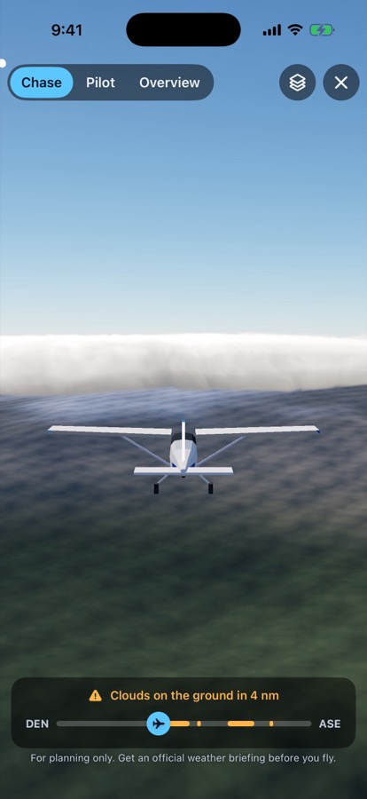 Chase view behind a small aircraft flying toward a wall of cloud over the Rockies.